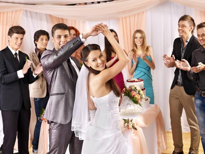 Bride & groom having fun with their guests dancing.